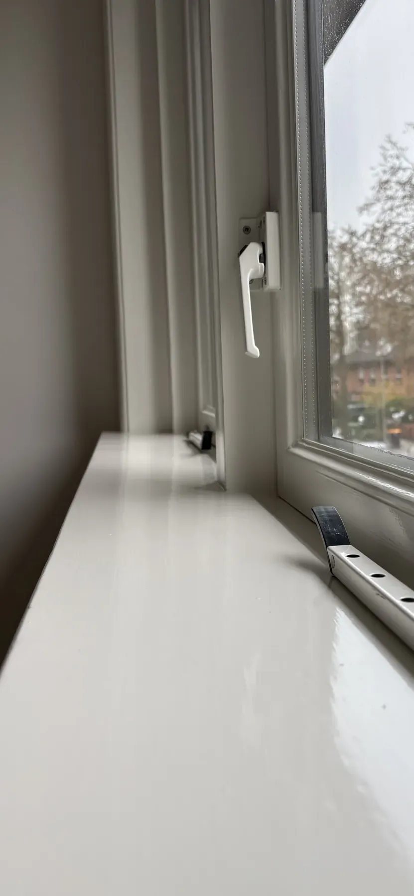 Binnenkozijn en vensterbank strak afgelakt rondom het glas